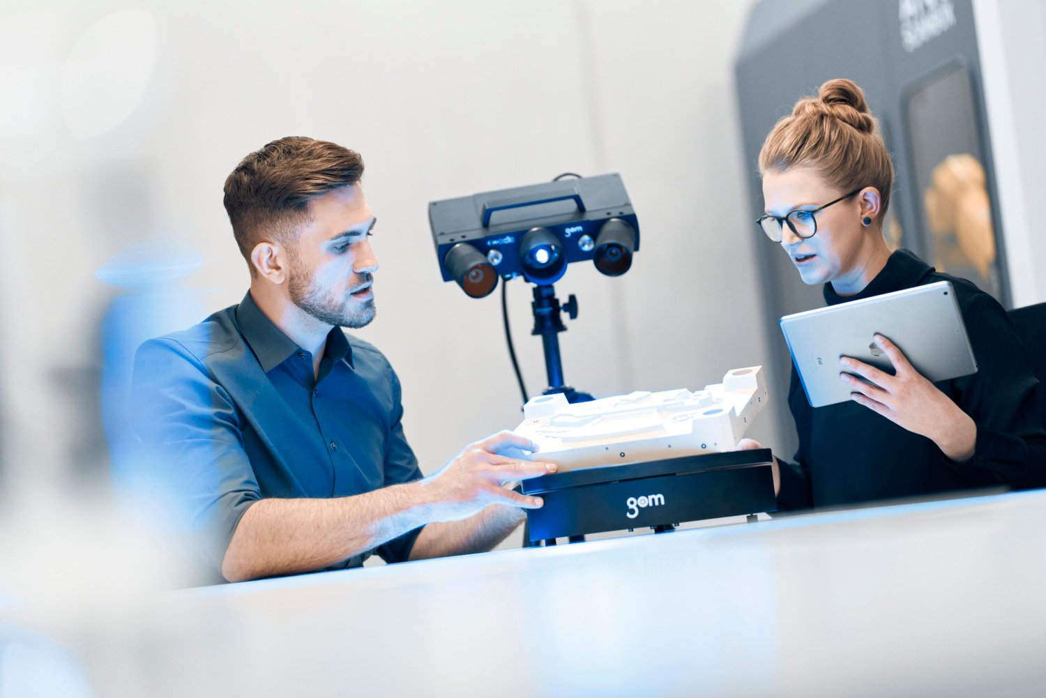 Two trilion engineers scanning a plastic part with the ATOS Q scanner