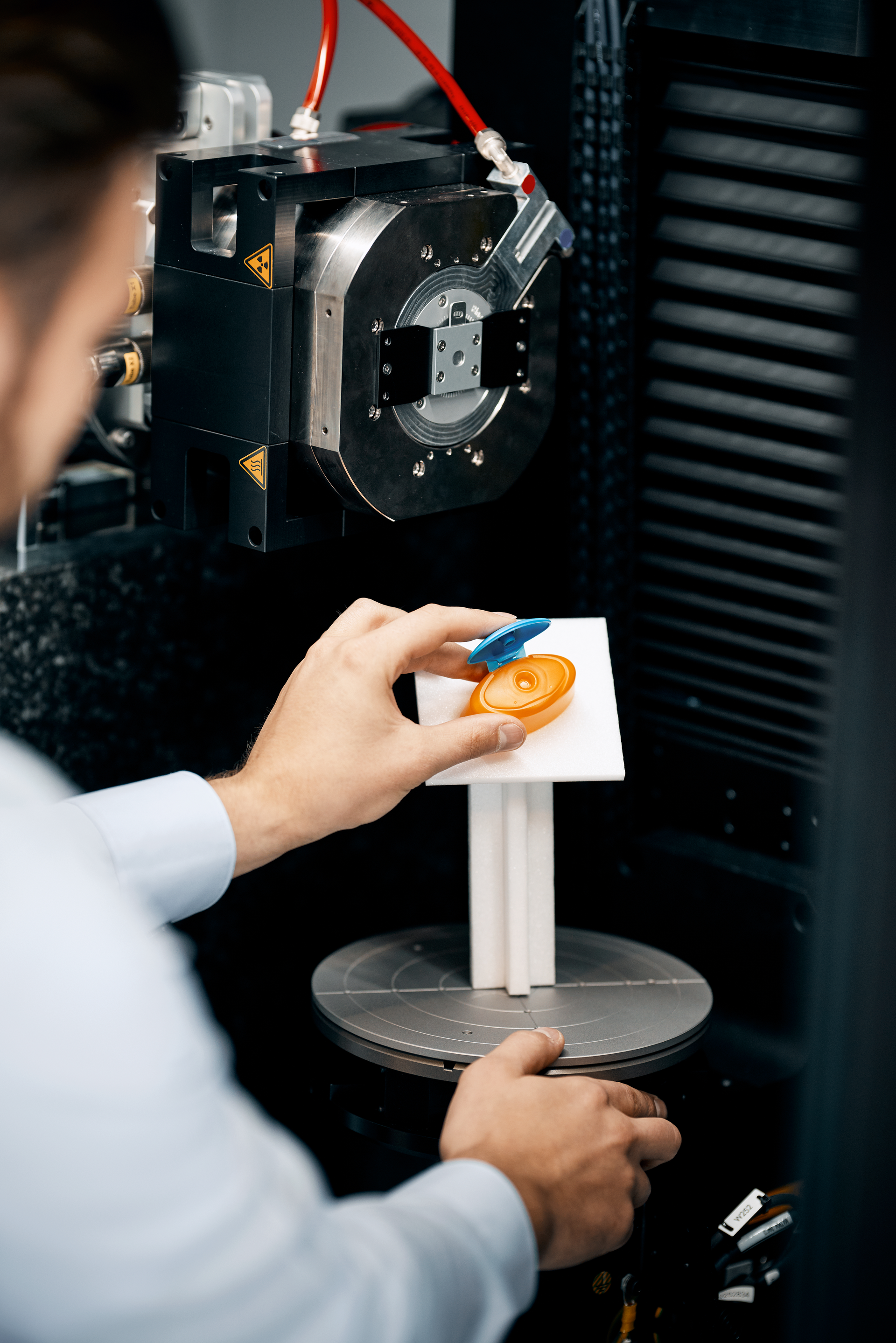 person putting part in the GOM CT