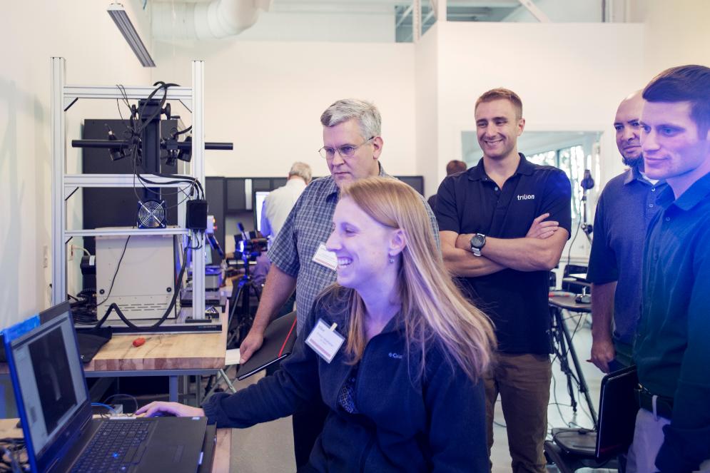 Woman being trained on how to us ARAMIS optical strain system